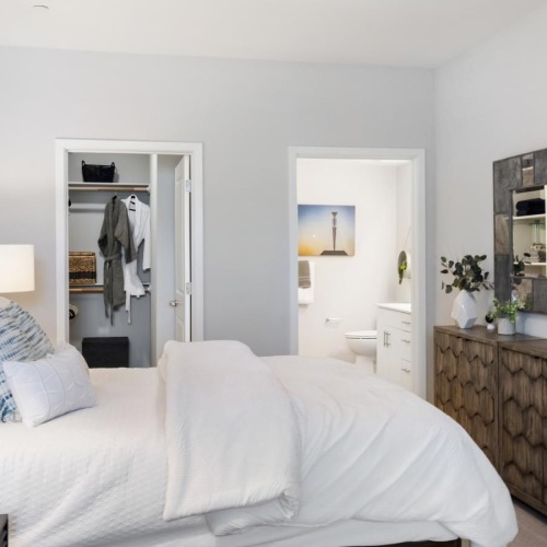 a bedroom with a bed and a mirror