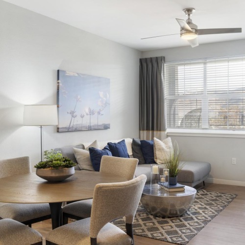a living room with a couch, tables and chairs