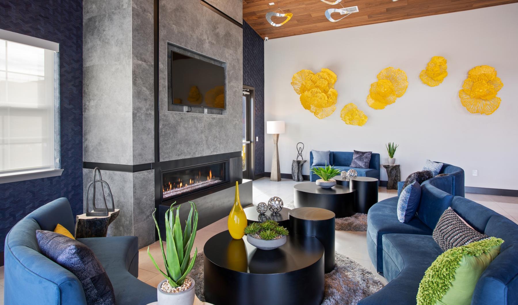 a lounge with couches, tables and a fireplace